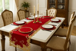 Luxurious dining table with an elegant red and gold embroidered table runner, set with fine china, gold candlesticks, and vintage-style chairs in a classic dining room.