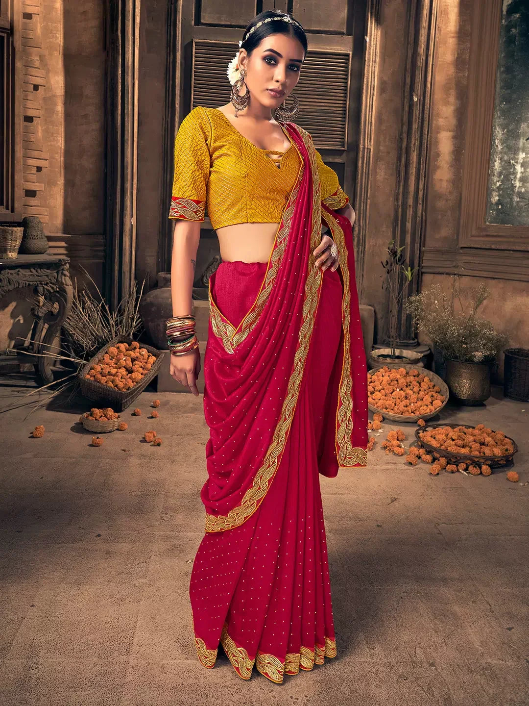 a woman wears red color sarees with yellow color blouse