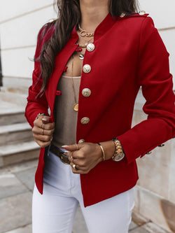 a woman wears red color winter jacket and a watch and rings in her hand