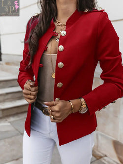 a woman wears red color winter jacket and a watch and rings in her hand