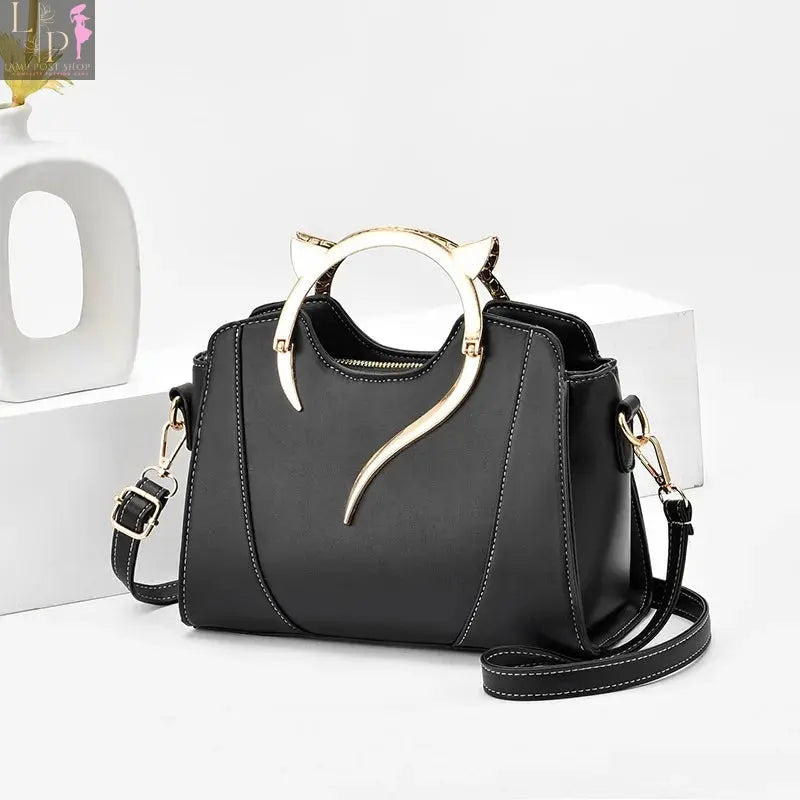 a black color women handbag on the table