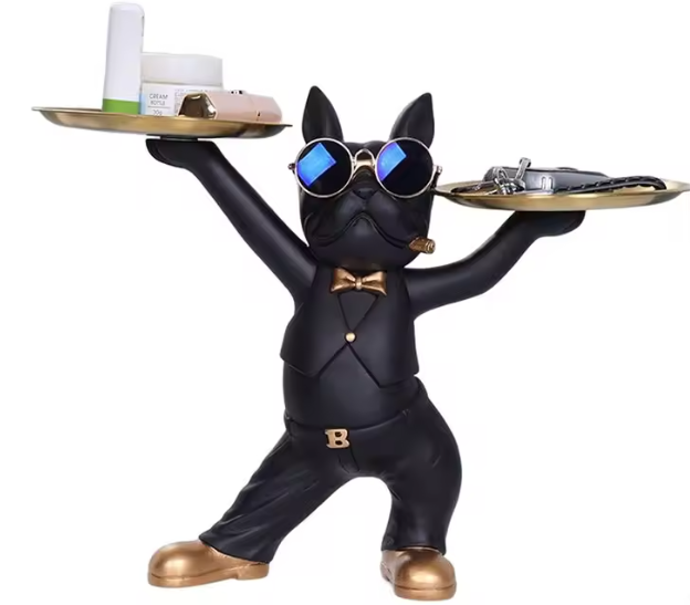 Black French bulldog figurine wearing blue-tinted sunglasses, a gold bow tie, and gold shoes, standing upright with both arms raised to hold two round gold trays—perfect for displaying keys, cosmetics, or small décor items.