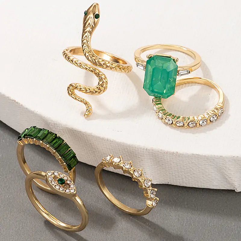 Gold vintage ring set by Lamp Post featuring multiple ornate rings with intricate designs and antique-style details.