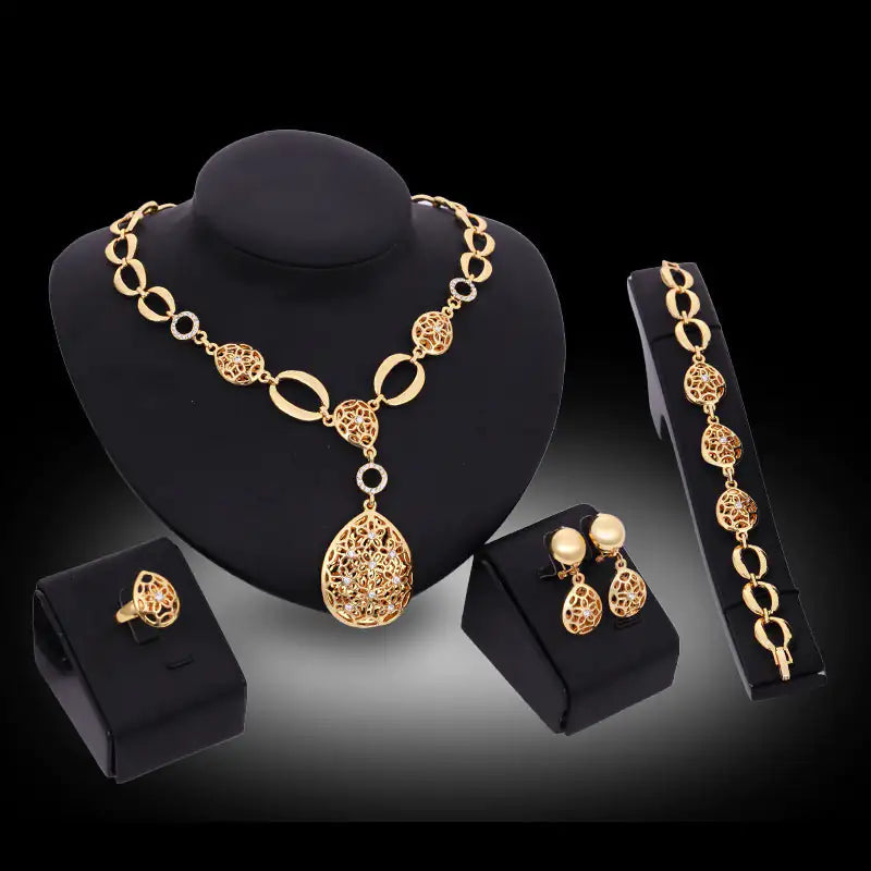 Gold Indian bridal jewelry set for women, featuring intricate traditional design with earrings, necklace, and matching accessories.