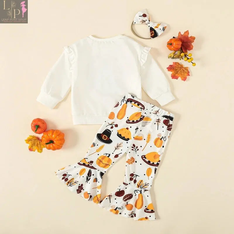 Toddler girl Thanksgiving outfit by Lamp Post featuring a turkey print long sleeve sweatshirt and matching headband for ages 6M-3Y.