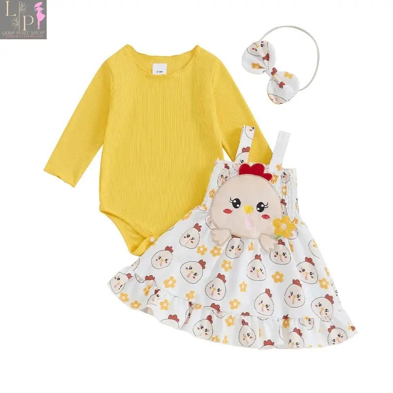 Baby girl in yellow Thanksgiving jumpsuit with long sleeves and turkey print, by Lamp Post, for festive holiday photos.