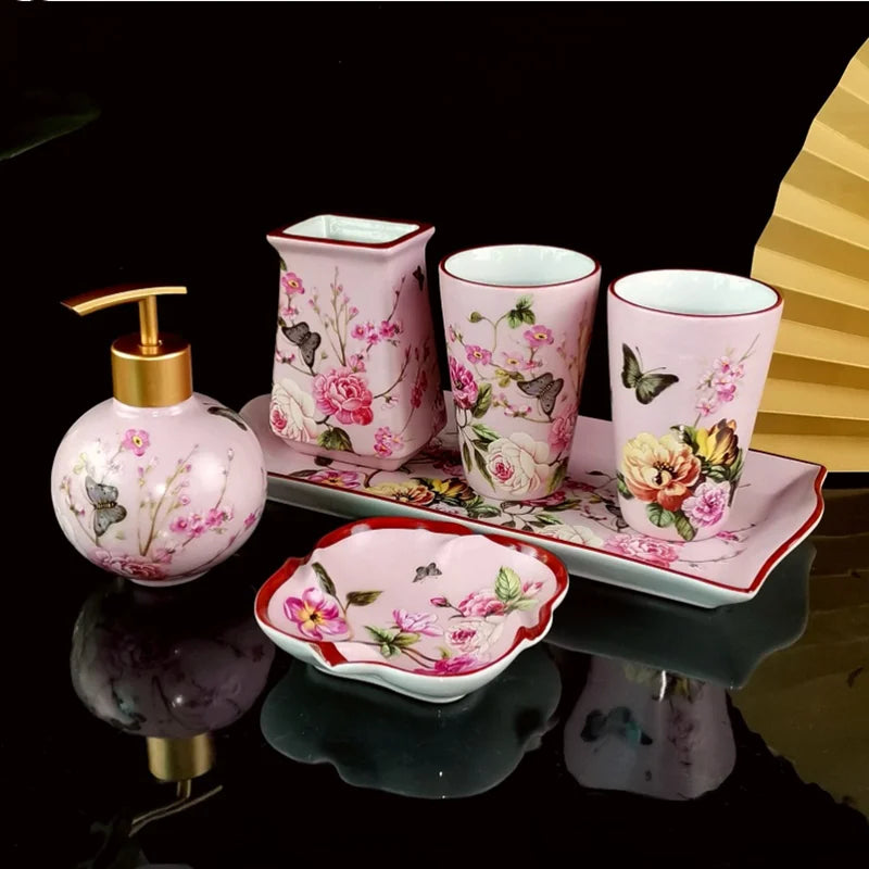 Luxury Bath Accessories Set by Lamp Post with pink rose pattern ceramic toothbrush holder, soap dispenser, soap dish, and bathroom cup.
