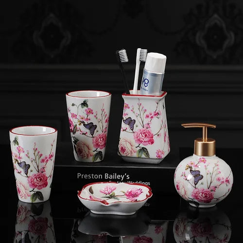 Lamp Post luxury bath accessories set with pink rose pattern, includes ceramic toothbrush holder, soap dispenser, soap dish, and bathroom cup.