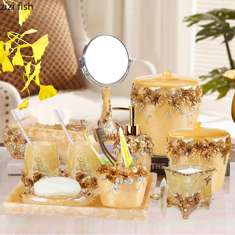 Lamp Post gold resin bath accessories set including lotion bottle, toothbrush holder, soap dish, tissue box, and toilet brush.