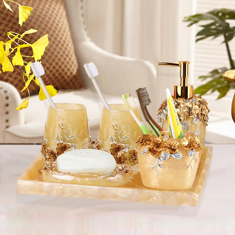 Lamp Post gold resin bath accessories set with lotion bottle, toothbrush holder, soap dish, tissue box, and toilet brush.