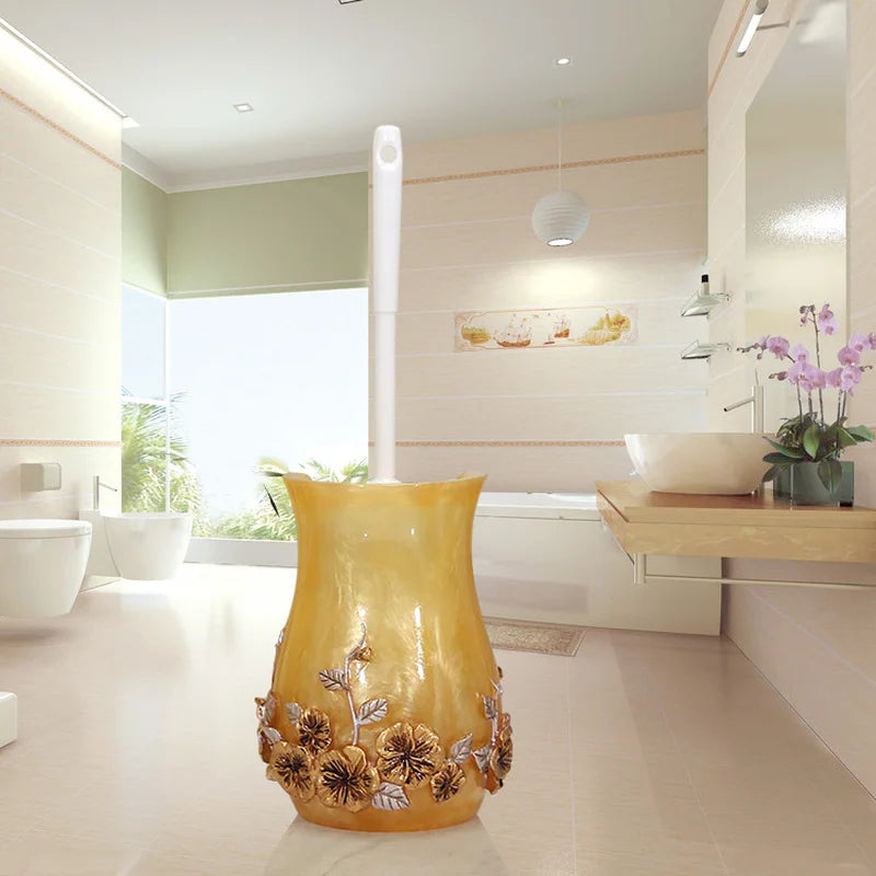 Lamp Post gold resin bath accessories set including lotion bottle, toothbrush holder, soap dish, tissue box, and toilet brush.