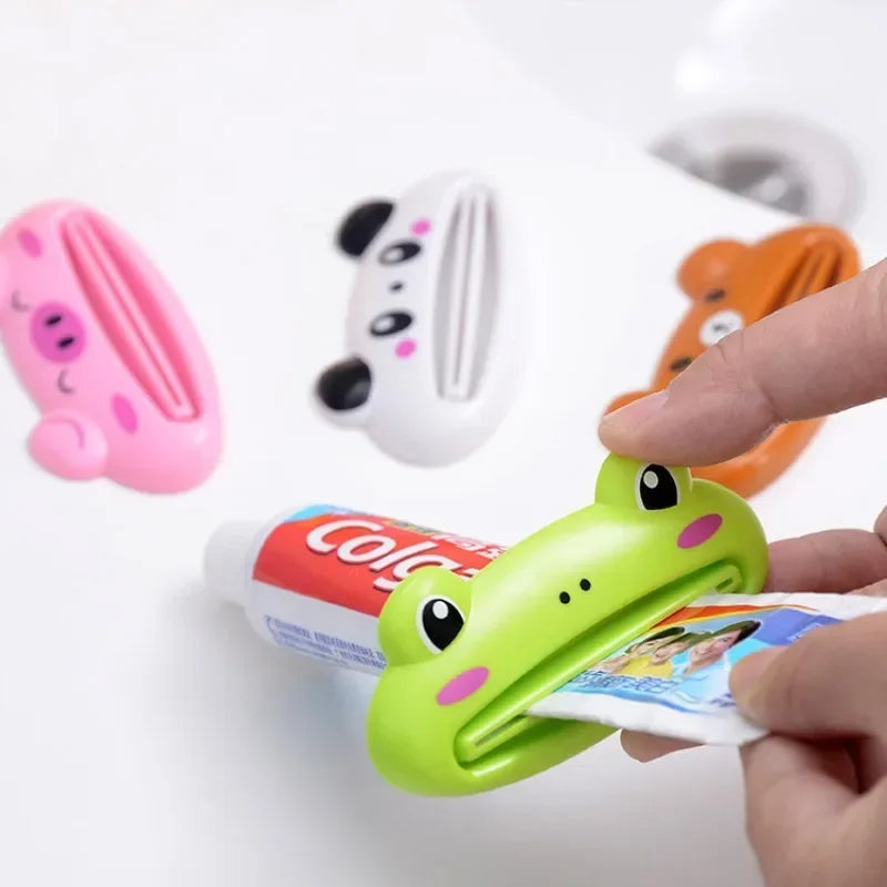 Pink cartoon rolling toothpaste squeezer dispenser for kids, Lamp Post bathroom tool for easy toothpaste tube squeezing.