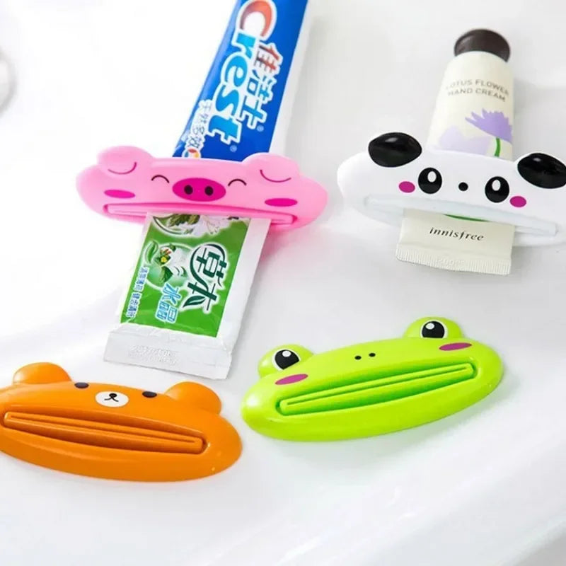 Pink cartoon rolling toothpaste squeezer dispenser for kids, Lamp Post bathroom tool to easily squeeze toothpaste from tubes.