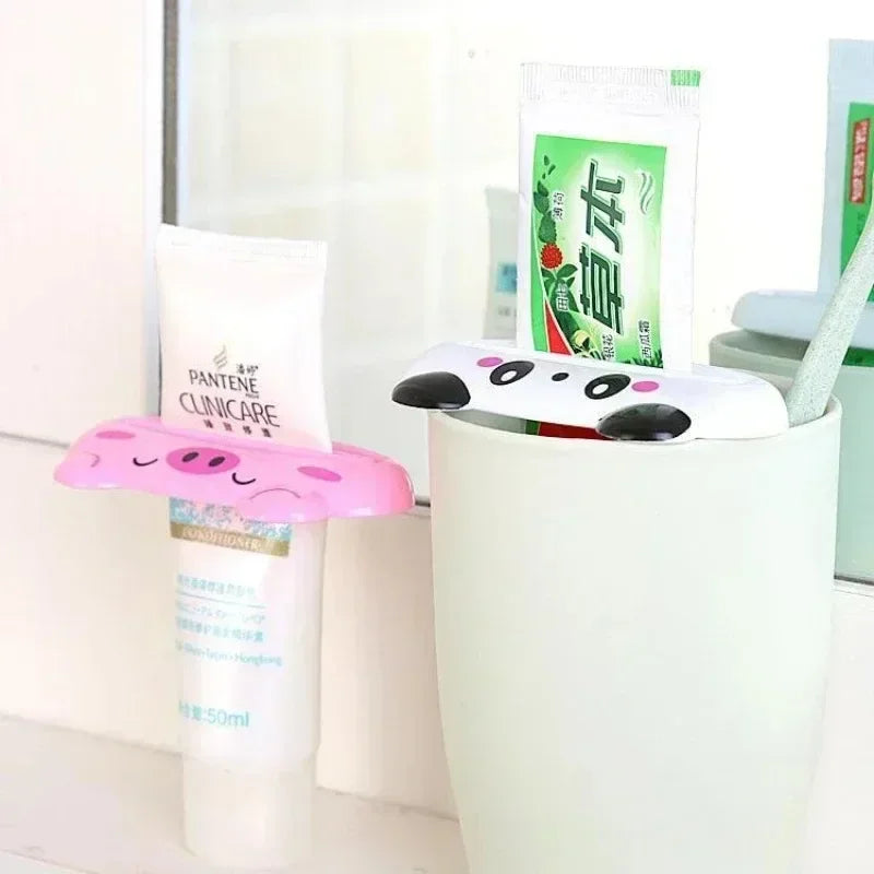 Pink cartoon rolling toothpaste squeezer dispenser from Lamp Post, a kid-friendly bathroom tool for easy toothpaste tube squeezing.