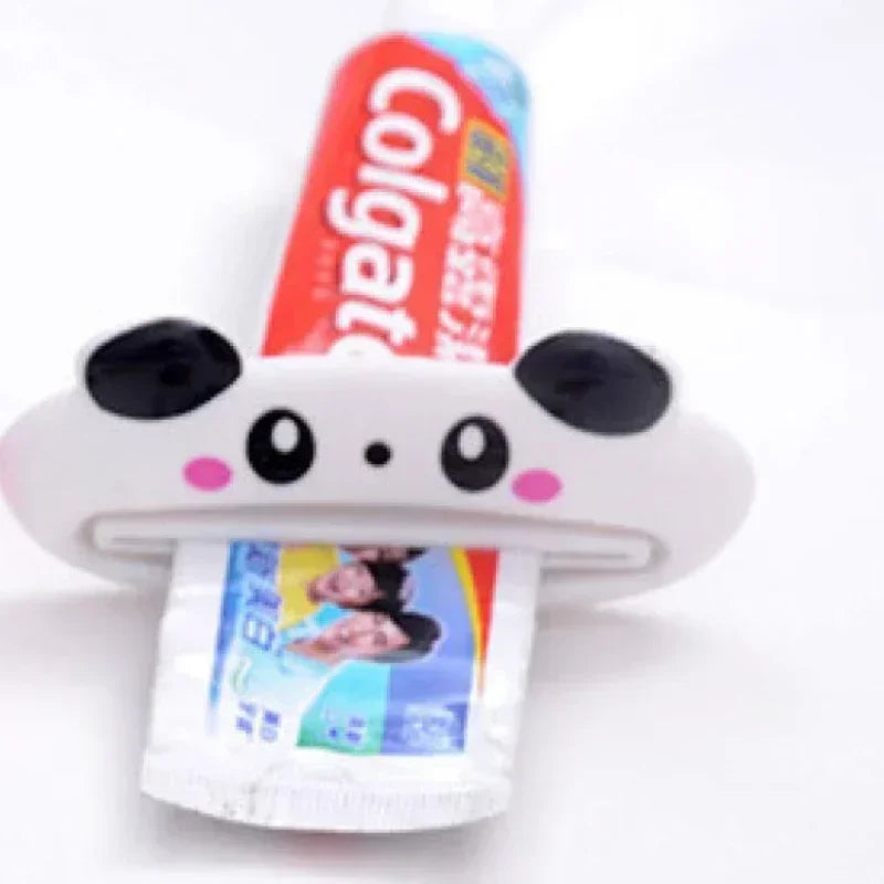 Pink cartoon rolling toothpaste squeezer dispenser by Lamp Post, a fun bathroom tool for kids to easily squeeze toothpaste from tubes.