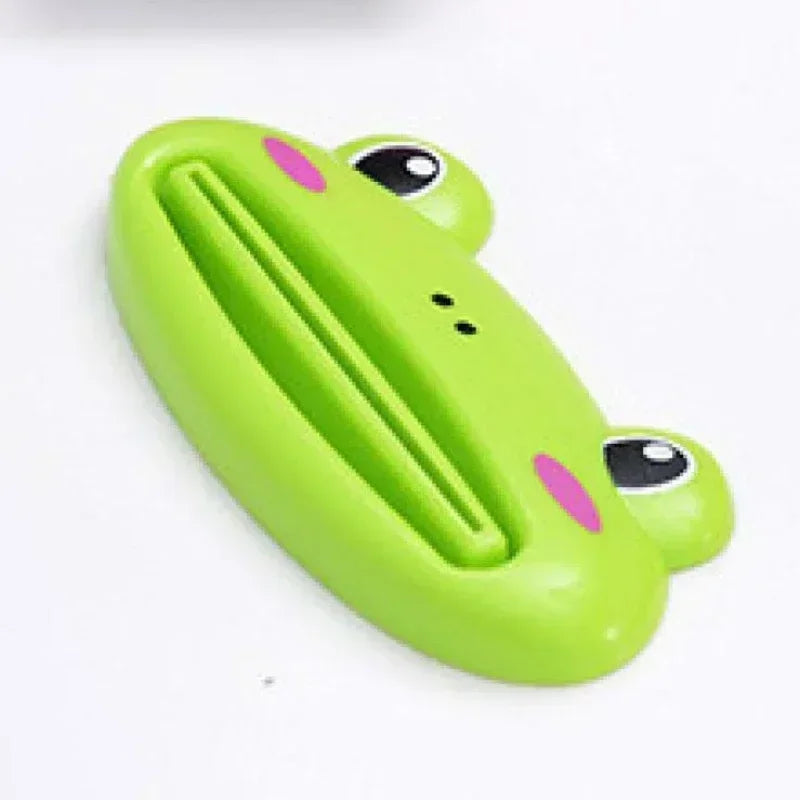 Pink cartoon rolling toothpaste squeezer dispenser by Lamp Post, a fun kid-friendly bathroom tool for easy toothpaste tube squeezing.