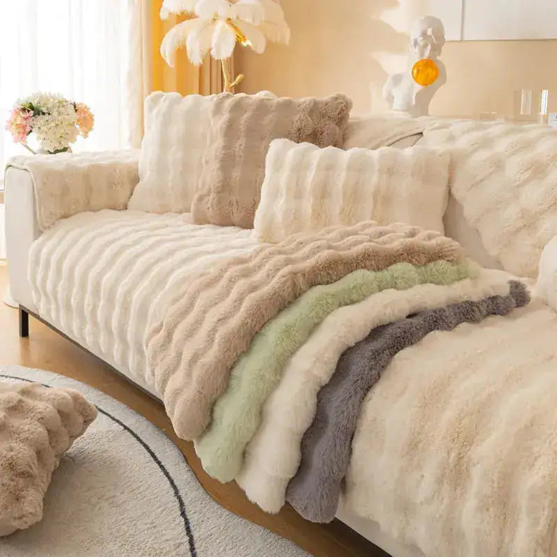 Beige Lamp Post non-slip sofa covers draped over a sofa, showing their fit and textured fabric for protection and style.