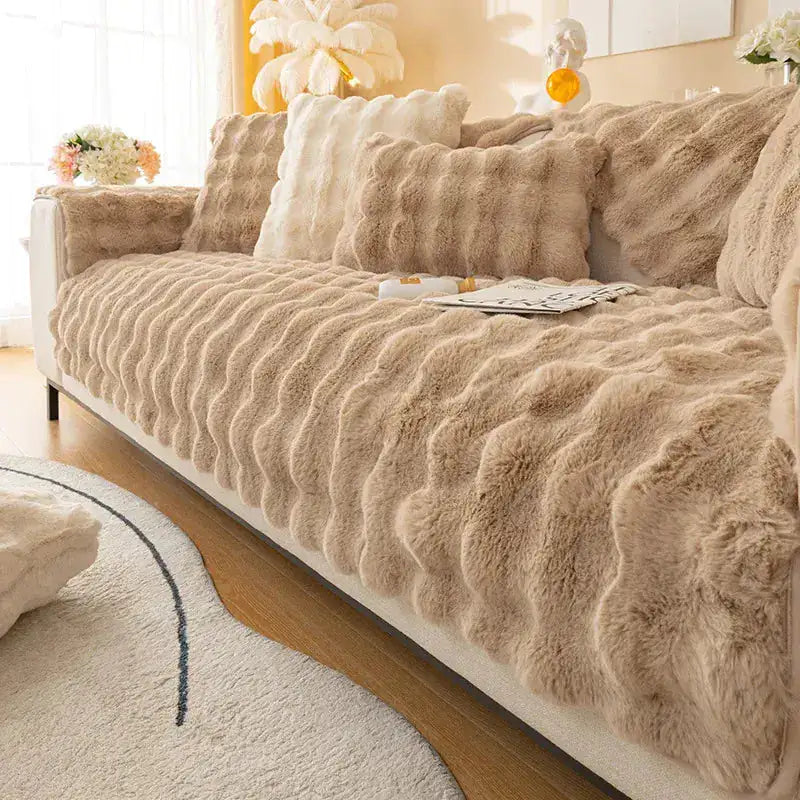 Beige Lamp Post non-slip sofa covers draped over a sofa, showing their snug fit and textured fabric for protection and style.