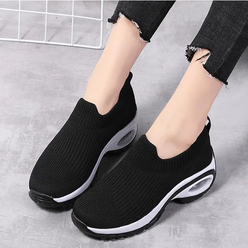 Black women's walking sneakers by Lamp Post featuring comfortable design and durable rubber soles.