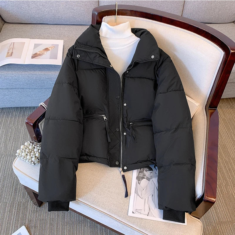 Black medium winter jacket for women by Lamp Post, shown on a model with a cozy, insulated design and stylish collar.