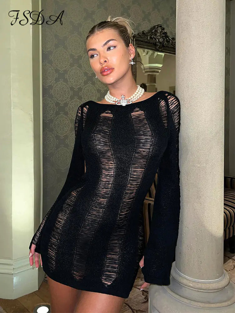 Black women’s long sleeve backless dress by Lamp Post, displayed on a mannequin, showcasing a sleek, elegant evening style.