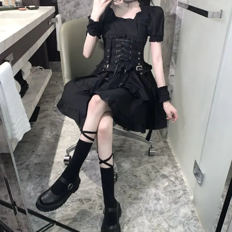 Gothic women’s black dress by Lamp Post featuring a fitted silhouette, long sleeves, and a lace-up front for a stylish look.