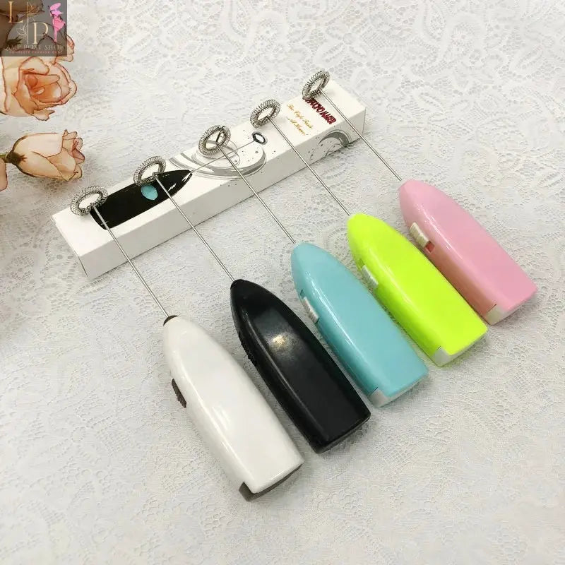 White Lamp Post mini electric coffee blender and handheld egg whisk mixer for drinks and milk, compact kitchen appliance.