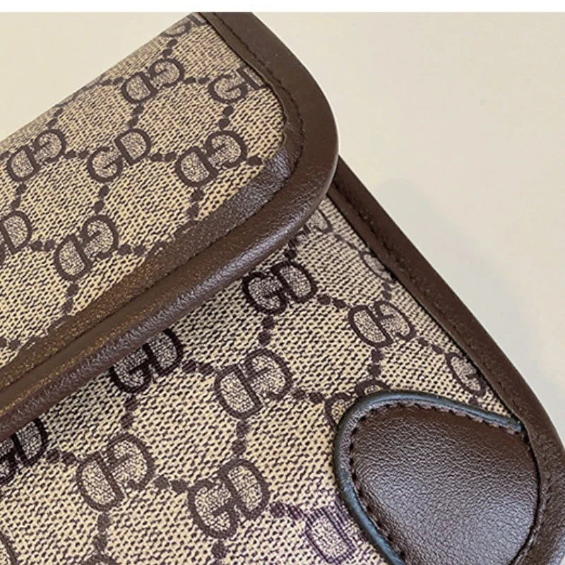 Lamp Post brown geometric print quilted shoulder bag with metal logo, flap closure, magnetic snap, and adjustable crossbody strap.