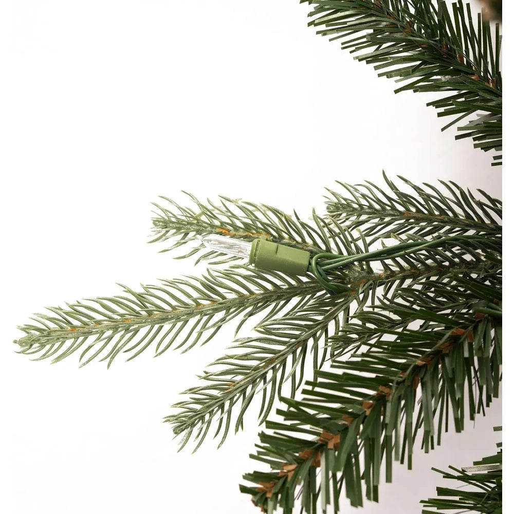 9-foot slim Christmas tree by Lamp Post with 900 warm lights and metal stand, perfect for festive holiday decoration.