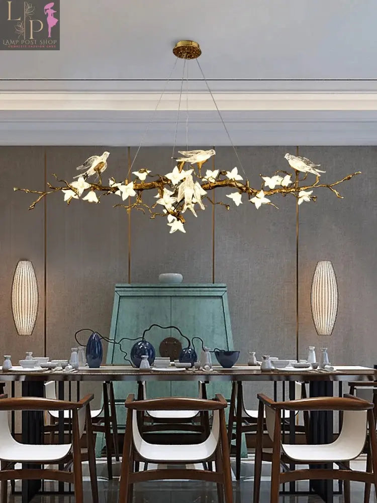 Copper LED restaurant chandelier with artistic swallow and branch design, suitable for living rooms and tea rooms.
