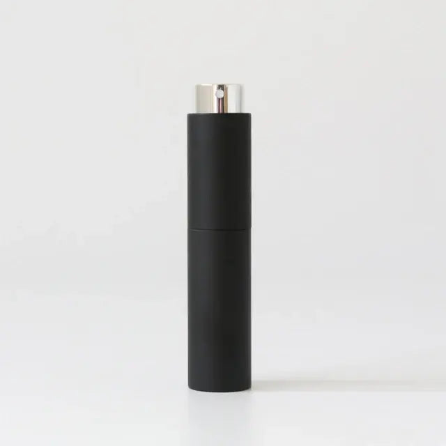 Refillable portable mini women’s perfume glass bottle by Lamp Post, compact and sleek for on-the-go fragrance application.