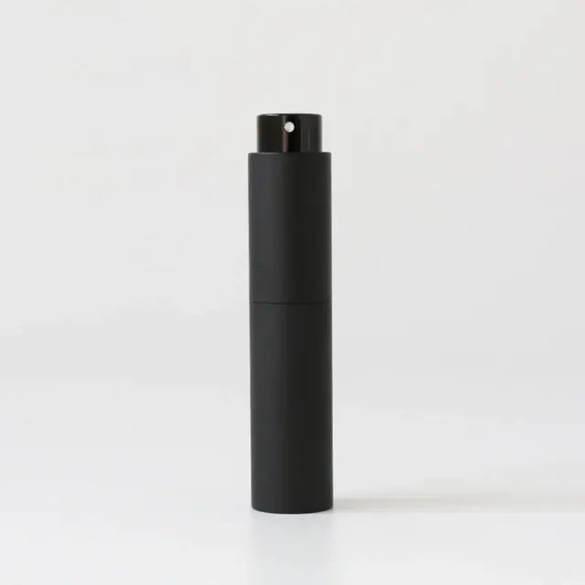 Refillable portable mini women’s perfume glass bottle by Lamp Post, compact design for easy on-the-go fragrance application.