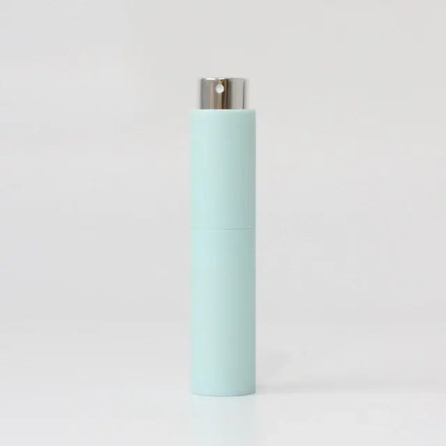 Refillable portable mini women’s perfume glass bottle by Lamp Post, compact and stylish for on-the-go fragrance application.