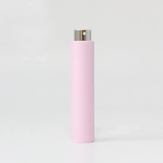 Refillable portable mini women’s perfume glass bottle by Lamp Post, compact and elegant for on-the-go fragrance application.