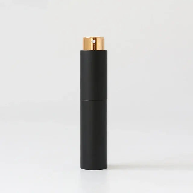 Refillable portable mini women’s perfume glass bottle by Lamp Post, compact and stylish for on-the-go fragrance application.