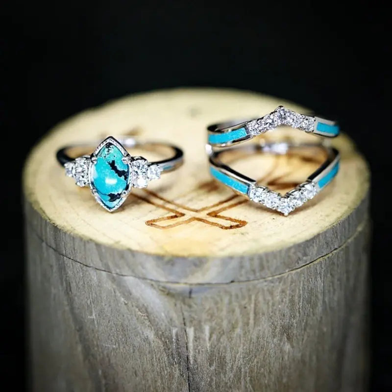 Women’s green stone ring set by Lamp Post featuring multiple gold-tone rings with vibrant green stones.