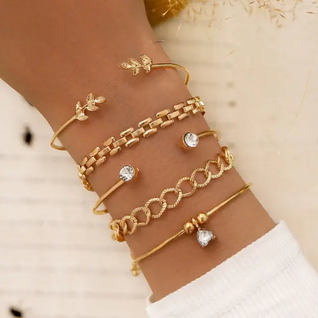 Gold inlaid bracelet jewelry set by Lamp Post featuring elegant design and intricate detailing.