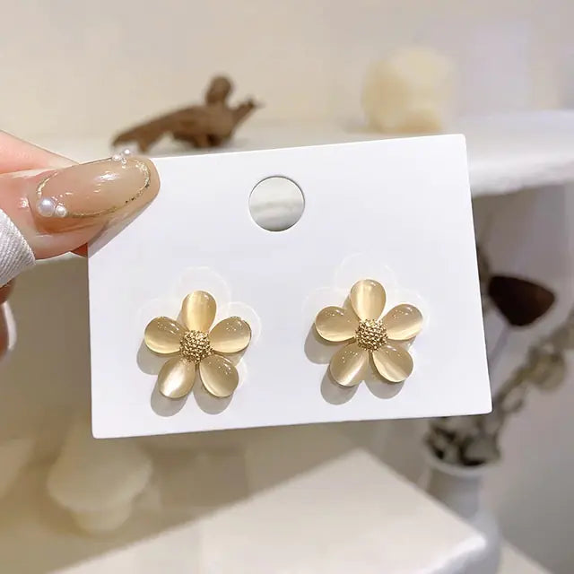 Gold flower earrings set by Lamp Post featuring delicate floral design and elegant dangle style for a stylish accessory.