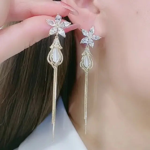 Gold flower earrings set by Lamp Post featuring delicate floral design and elegant dangle style for women.