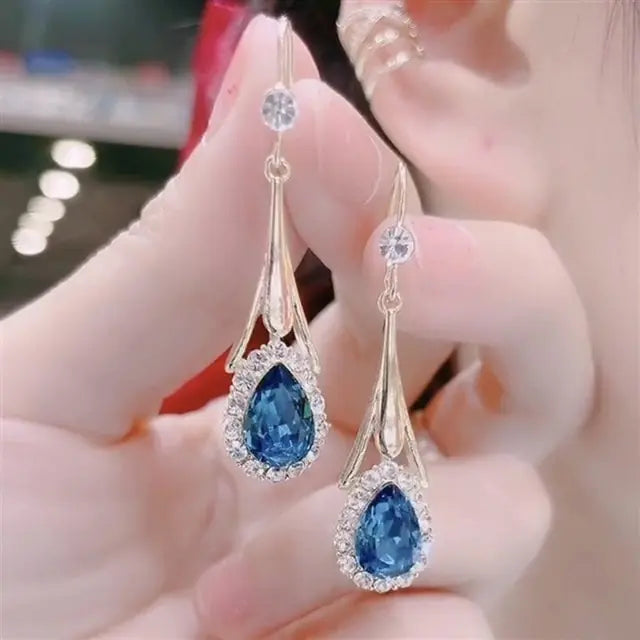 Gold flower earrings set by Lamp Post featuring delicate floral designs and elegant dangle style.