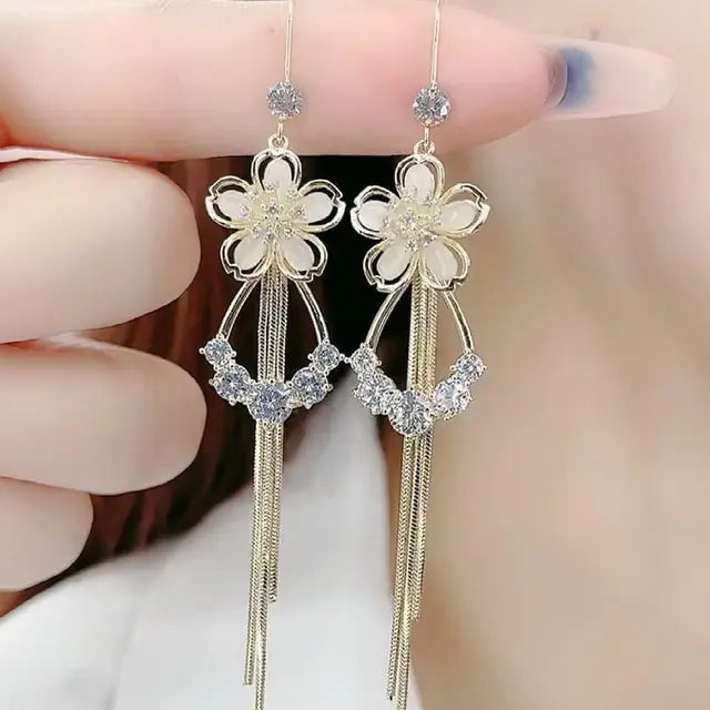 Gold flower earrings set by Lamp Post featuring delicate floral design and elegant dangle style.