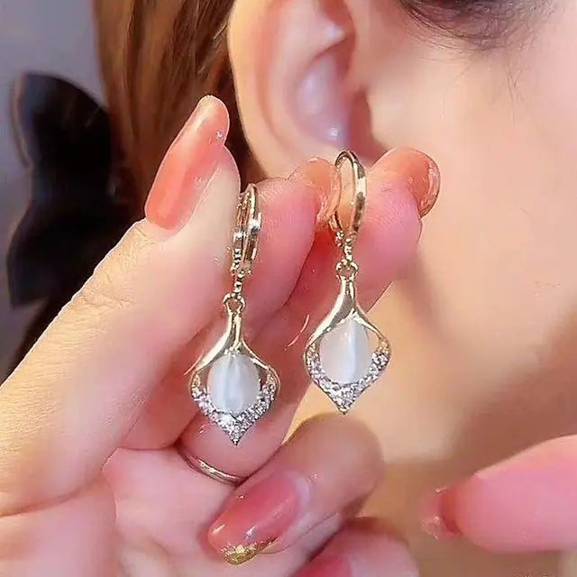Gold flower earrings set by Lamp Post featuring delicate floral design and elegant dangle style, perfect for accessorizing.
