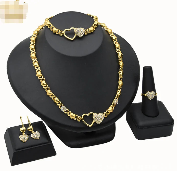 Gold wedding and engagement jewelry set by Lamp Post featuring a matching ring and necklace with elegant design.