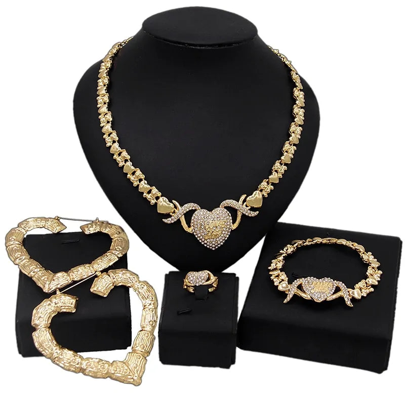 Gold wedding and engagement jewelry set by Lamp Post featuring matching rings and necklace with intricate designs.