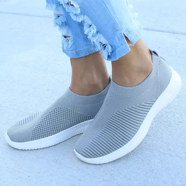 Gray women's sneakers by Lamp Post featuring stylish design and comfortable fit, displayed on a plain white background.