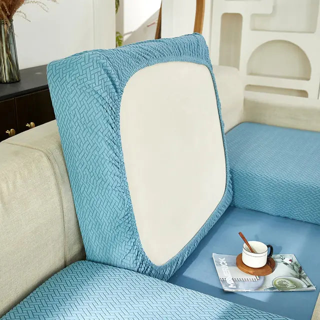 Green universal sofa cover by Lamp Post with back cushions, designed to protect and refresh your sofa's appearance.