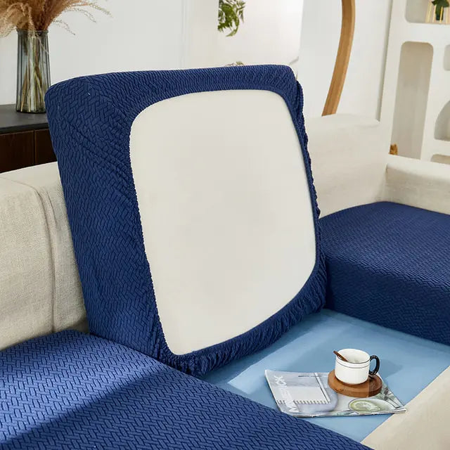 Green universal sofa cover by Lamp Post with back cushion, designed to fit and protect standard sofas.
