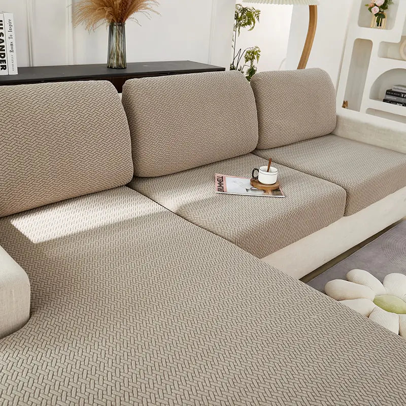 Green universal sofa cover by Lamp Post with back cushion, designed to protect and refresh standard sofas.