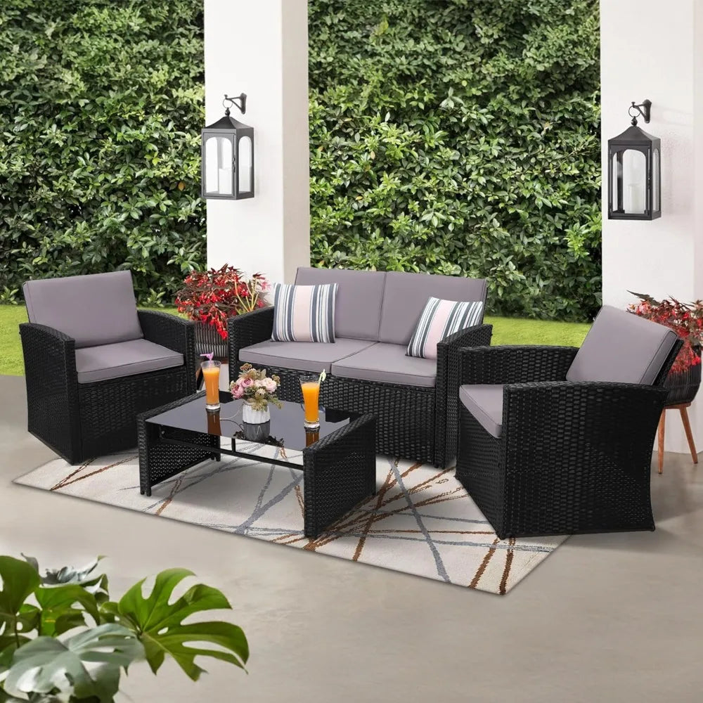Brown rattan small living room sofa set by Lamp Post, includes sofa, two chairs, and coffee table for porch or patio seating.