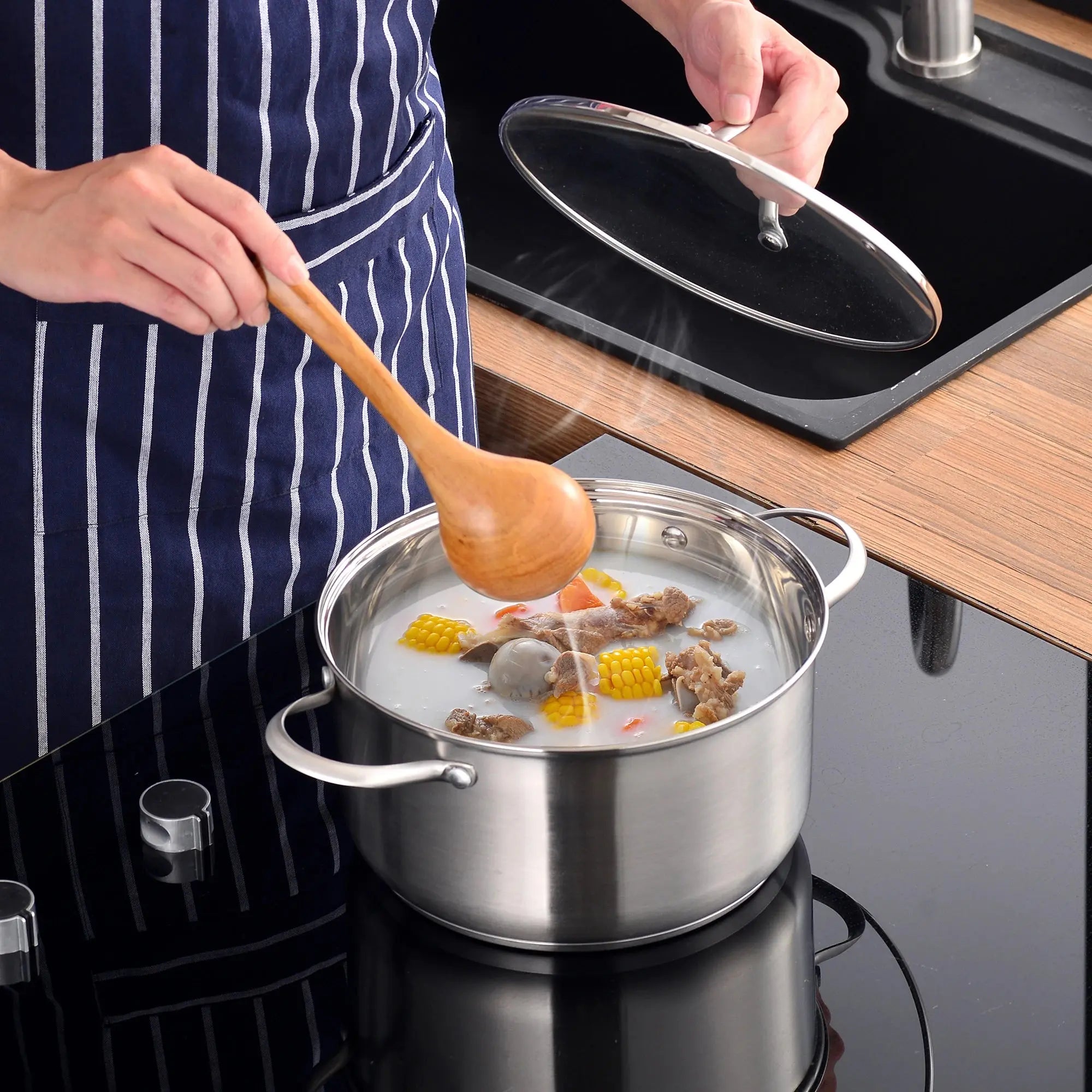 8/9/14-piece Velaze stainless steel cookware set by Lamp Post, induction-safe kitchen appliances arranged for cooking and storage.